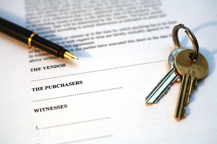 Buying a house paperwork with house keys