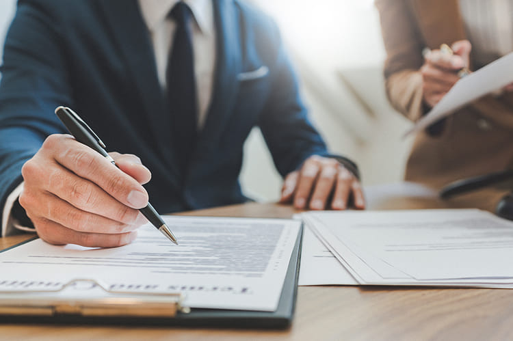 Signing paperwork in lawyers office
