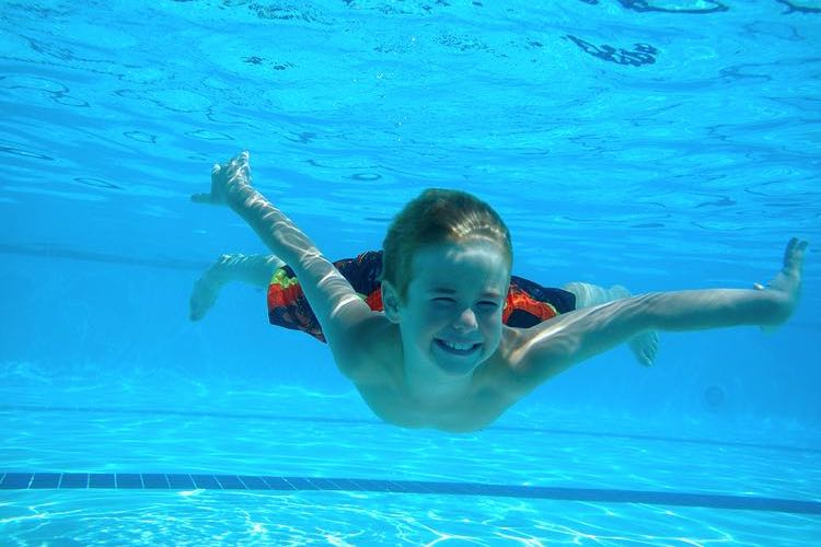 Boy smiling under water