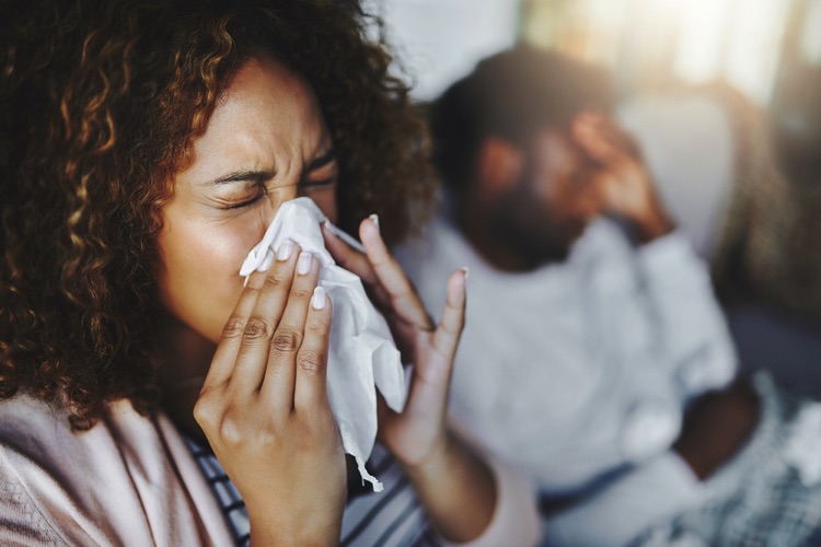 Flu season blowing nose