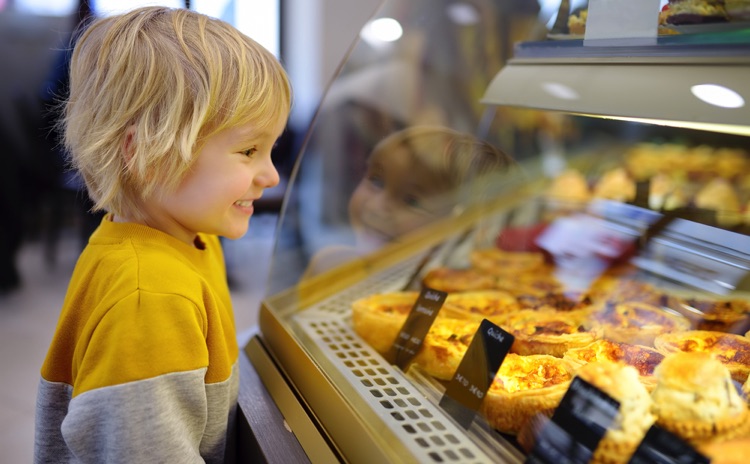 Kid admiring French cakes