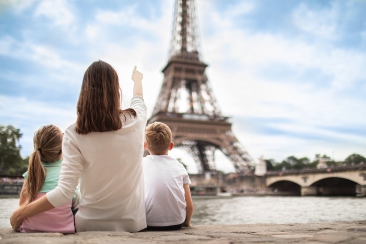 Mother with her kids looking at the Eiffel Tower