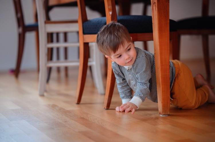 Kid crawling under the table