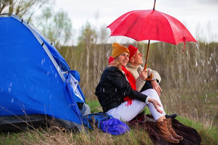 Couple camping in the rain